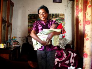 photo of woman holding baby