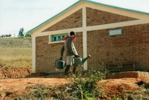 photo of man walking near house