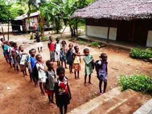 photo of children lined up in a school. yard in Madagascar