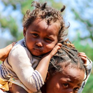 photo of young Malagasy child on back of Malagasy woman