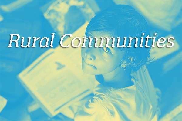 "Rural Communities" written in white font over a blue-tinted photograph of a Malagasy student looking up from a textbook